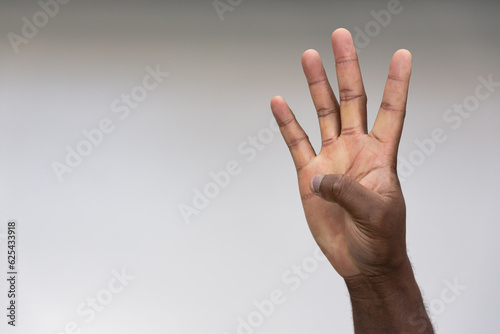 Hand of black African Man Pointing Up four fingers Gesture for number 4, Success, Goal, Direction concept on Isolated Background © 9nong