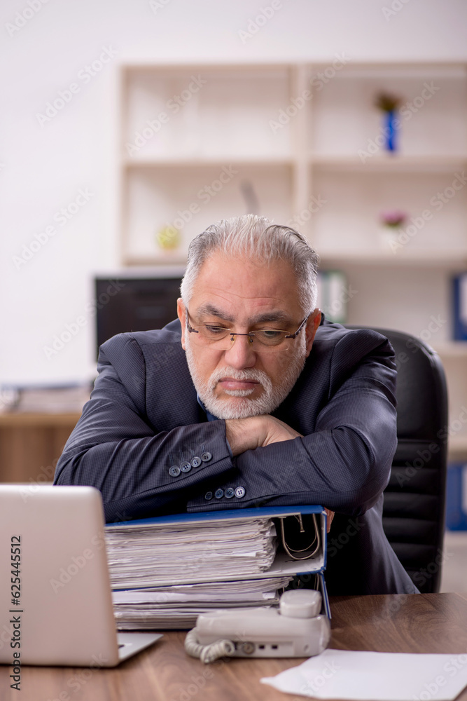 Old male employee and too much work in the office Old male employee and too much work in the office