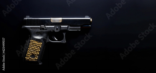 Gun with bullets on black background