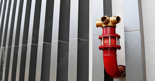 The red fire hydrant outside the building is decorated in a modern design, copy space photo