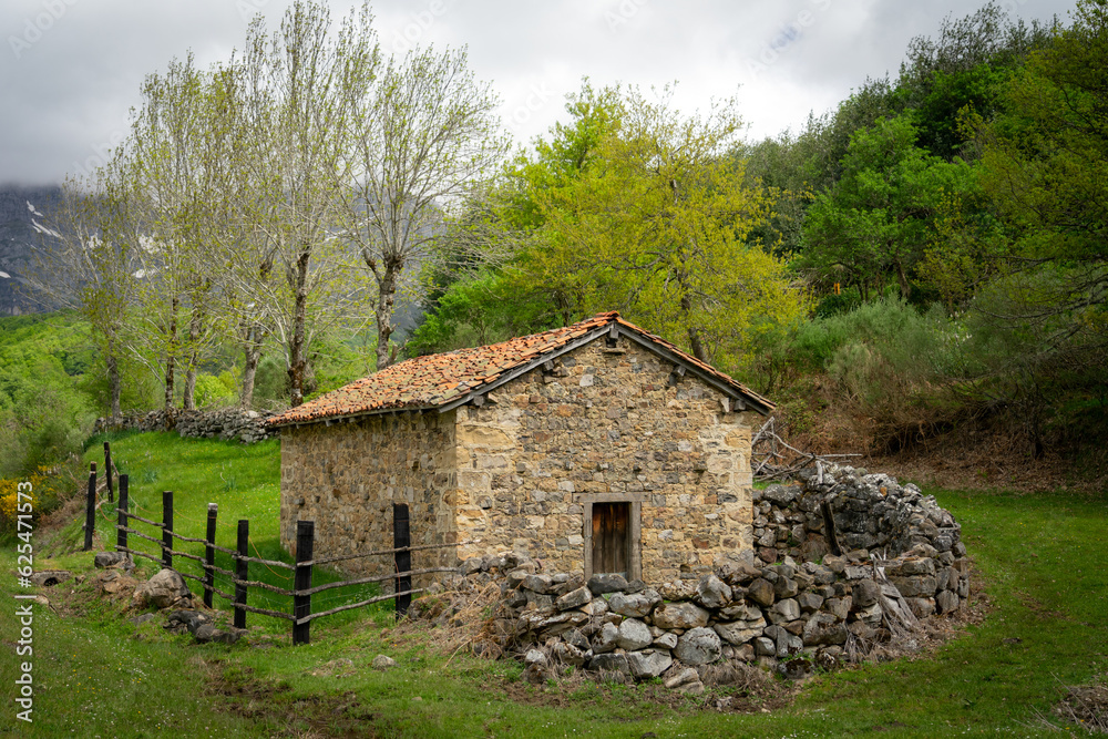 Typical stone barn of Picos de Europa to spend the winter with the livestock. Leon, Spain