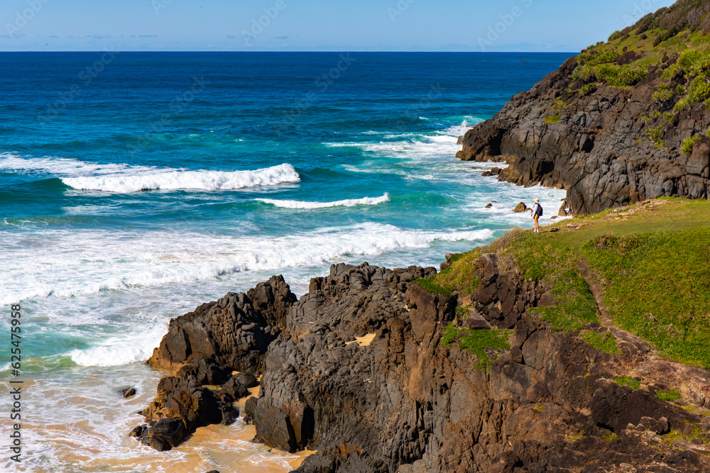 panorama of new south wales coast in hat head national park; green hills coverd with juicy grass by the ocean, beautiful beach surrounded by cliffs in australia, o'connors beach in hat head	