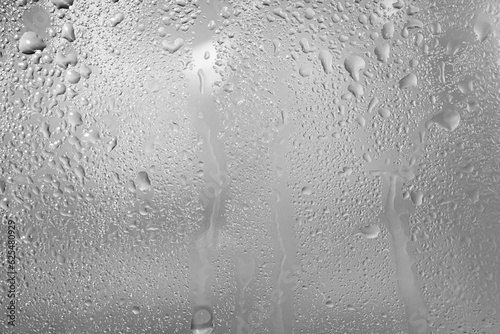 Gray background. Glass wet surface.
