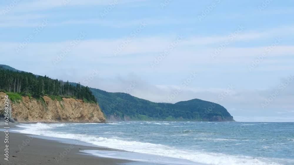 View of the coastline of the sea coast, rocks and green hills. Picturesque seascape. View of the coastline of the sea coast, rocks and green hills. Picturesque seascape.
