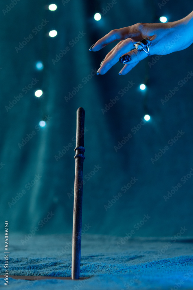 Obraz premium The sorcerer's hand reaches for the magic wand