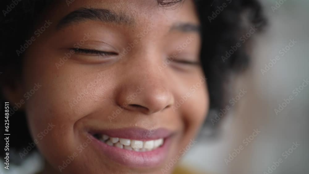 Portrait beautiful african american young woman standing alone in home. Girl look at camera, having wide toothy charming smile. Natural beauty, curly hair. House rest lifestyle. Concept appearance. Portrait beautiful african american young woman standing alone in home. Girl look at camera, having wide toothy charming smile. Natural beauty, curly hair. House rest lifestyle. Concept appearance.