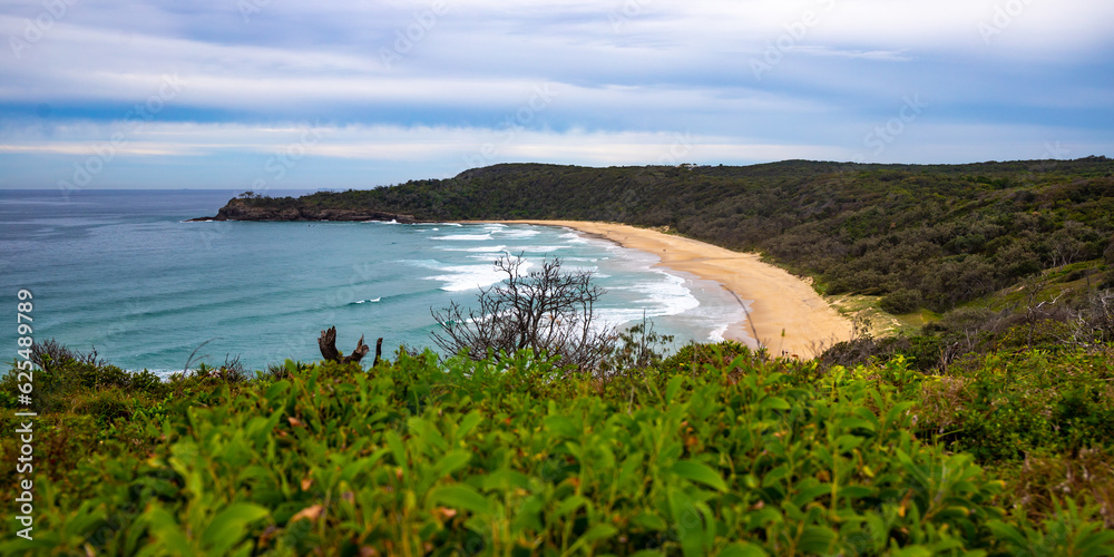 panorama of a beautiful long vast beach - Alexandria Bay and powerful waves. Coastline in Noosa National Park, Queensland, Australia, Sunshine Coast region panorama of a beautiful long vast beach - Alexandria Bay and powerful waves. Coastline in Noosa National Park, Queensland, Australia, Sunshine Coast region