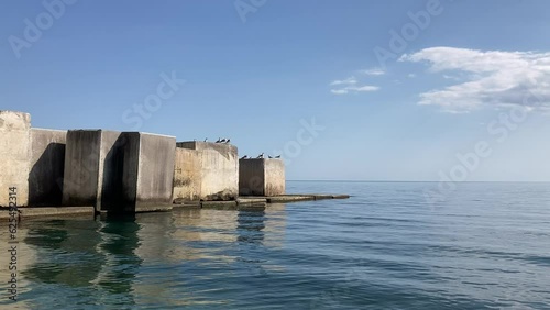 concrete cubes and seagulls, concept serenity view of sea