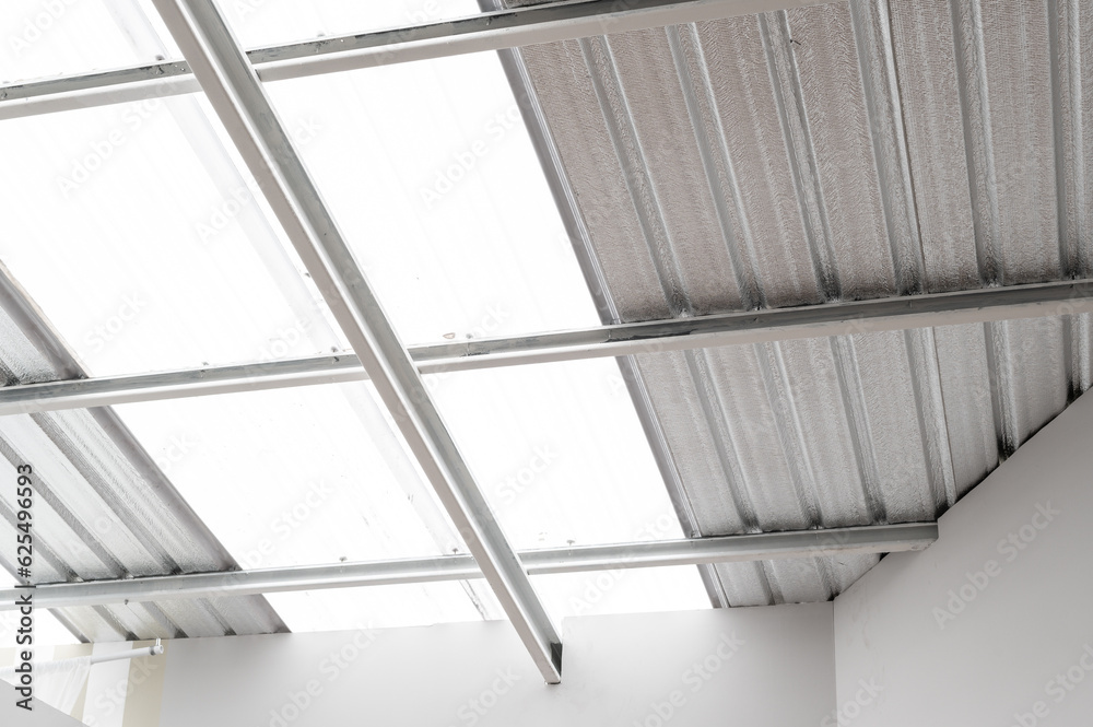 Obraz premium industrial grade metal roof insulation. heat resistant sheet foil provides thermal protection and energy efficiency. corrugated design and silver texture add modern and abstract touch to construction.