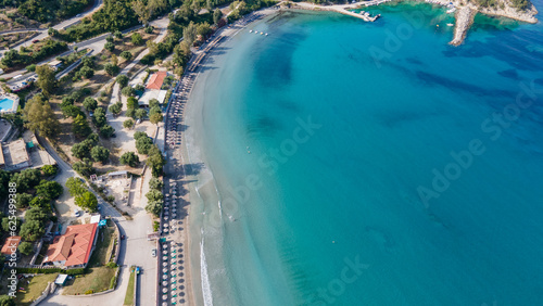 Bounty and pristine sandy shore with trees, Ionian Sea washes tropical coastline. Arillas Beach Syvota, Greece. Aerial view. View from above, aerial view of an emerald and transparent Mediterranean 