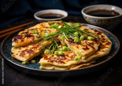 Scallion Pancakes served on a ceramic plate along with sauce
