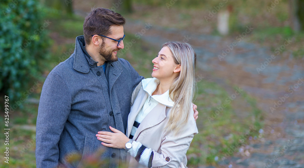 Obraz premium A portrait of a happy romantic couple walking outdoors in the surroundings of an old fortress