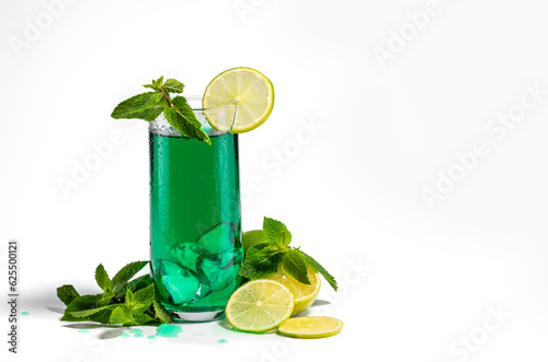 Juice in a glass goblet aromatic peppermint with lemon on a white background