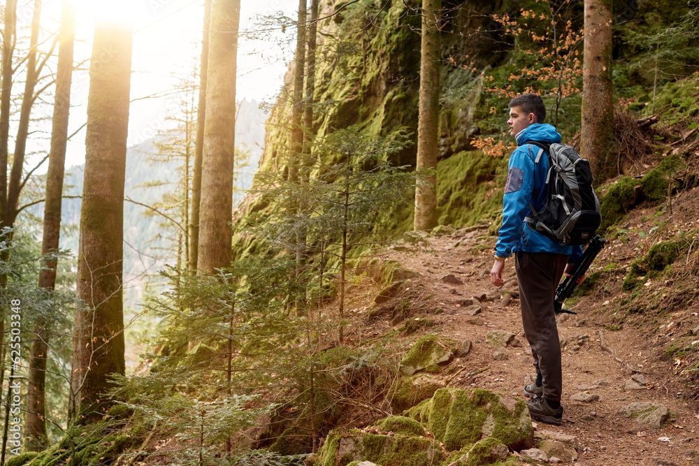 Traveler Man with backpack mountaineering Travel Lifestyle concept mountains on background Summer trip vacations outdoor. Concept of travel and healthy, active lifestyle. Young guy with dreadlocks