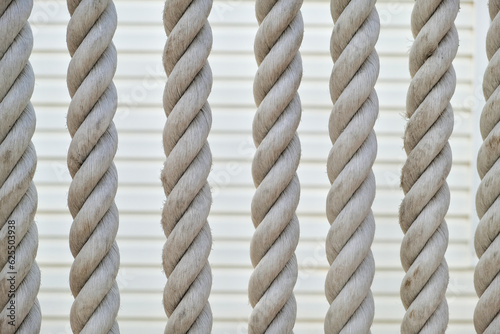 Beautiful texture of vintage rope background. rope string vertical hang in front of wall
