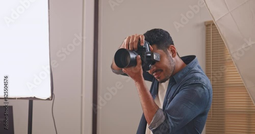 Professional male photographer working in studio. Photographer shooting model with flashlight.