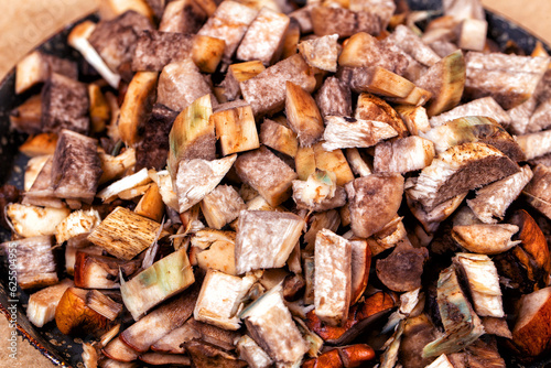 Raw chopped mushrooms in a frying pan. Close-up