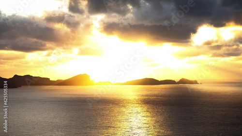 Timelapse of passing clouds with sunrise in São Lourenço Madeira. Portufal. Fixed view photo