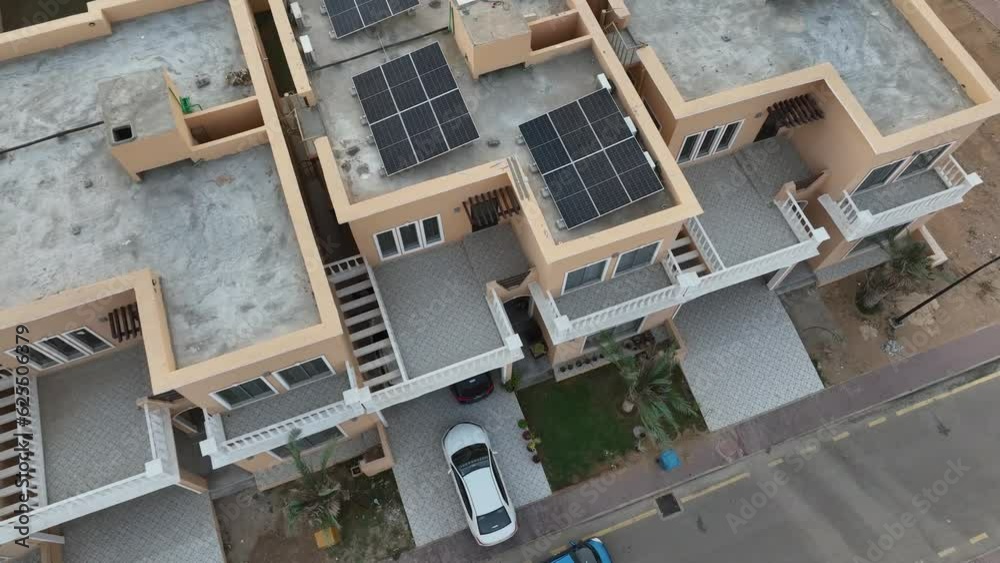 Aerial view of identical rows of homes with solar panels on rooftops Aerial view of identical rows of homes with solar panels on rooftops