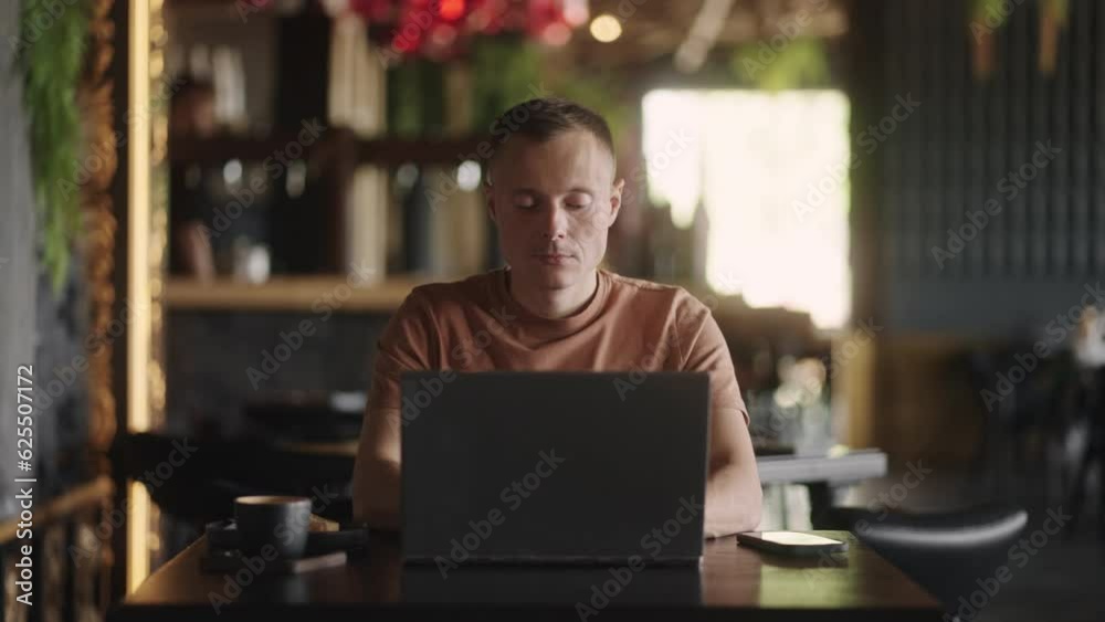 Web Designer Or IT Professional Working With Laptop In Cafe, Use Internet And Free Wi-Fi, Portrait Web Designer Or IT Professional Working With Laptop In Cafe, Use Internet And Free Wi-Fi, Portrait