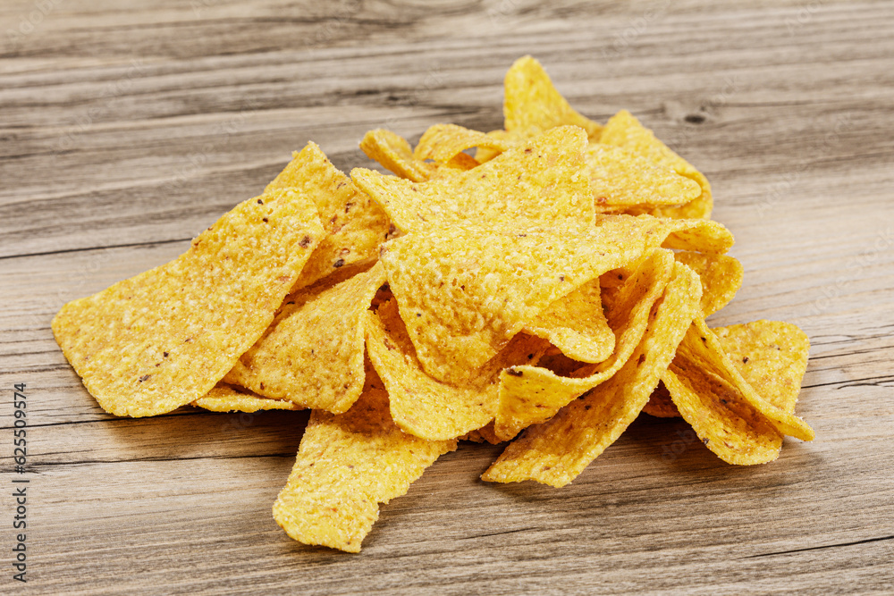 Delicious Roasted Corn Tortilla or Nacho Chips on wooden background Delicious Roasted Corn Tortilla or Nacho Chips on wooden background