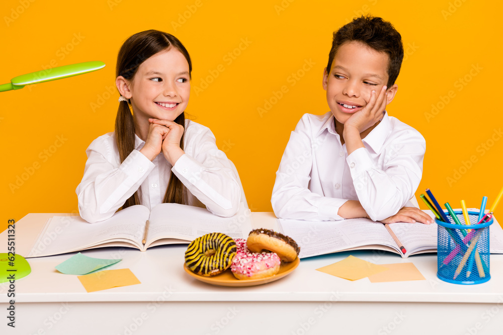 Photo of cute pupils clever students sit table ready for school lecture isolated on bright color background