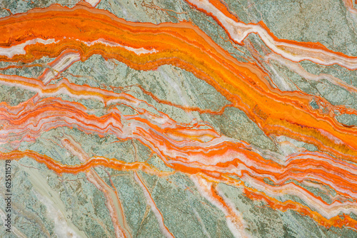 The unique texture of Onyx, bright saturated streaks of orange on a gray-green background
