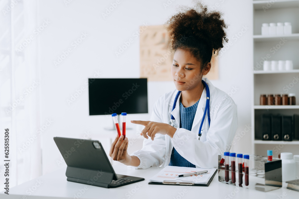 African doctor or consultant sitting at a desk writing sick note, surgery planning and prescription.and clinical report test results in office African doctor or consultant sitting at a desk writing sick note, surgery planning and prescription.and clinical report test results in office