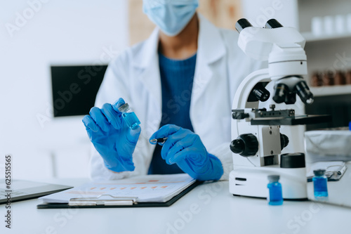 Modern medical research laboratory. African female scientist working with micro pipettes analyzing biochemical samples, advanced science chemical laboratory for medicine. .