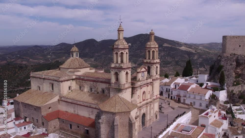 Flying close at Olvera church Spain with mountains in the background, aerial Flying close at Olvera church Spain with mountains in the background, aerial