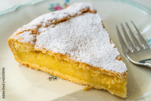 A piece of Custard cream cake with pine nuts. Traditional italian cake - torta della nonna or grandmother's cake. Tuscany pastry.
