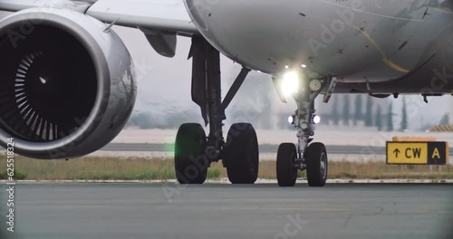 The wheels of a passenger plane drive down the airport runway after landing. Aviation and airplane flights. High quality 4k footage photo
