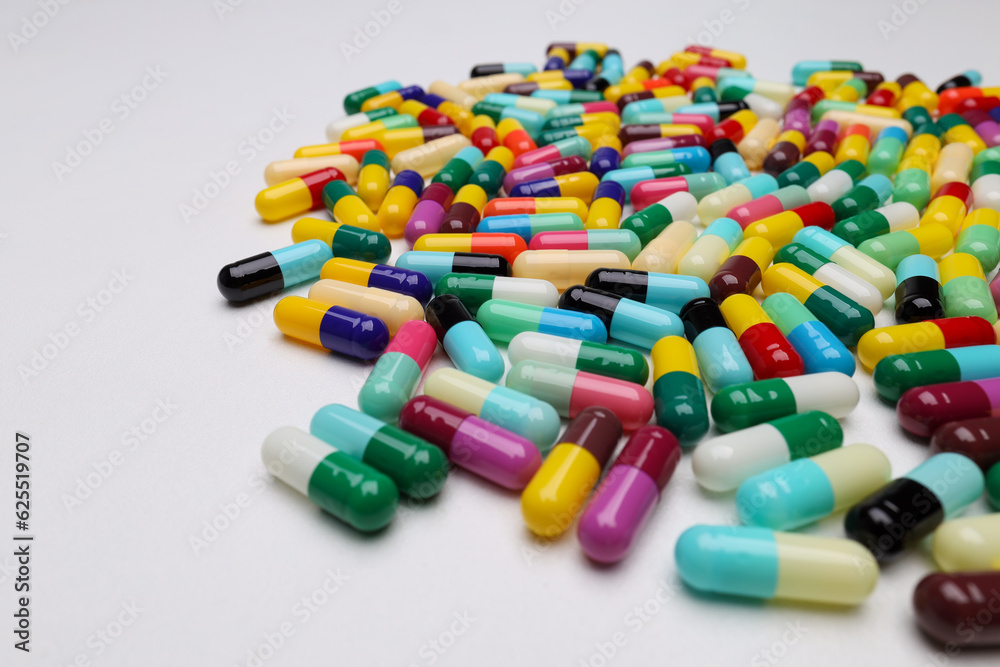 colored pill capsules placed on a white background colored pill capsules placed on a white background