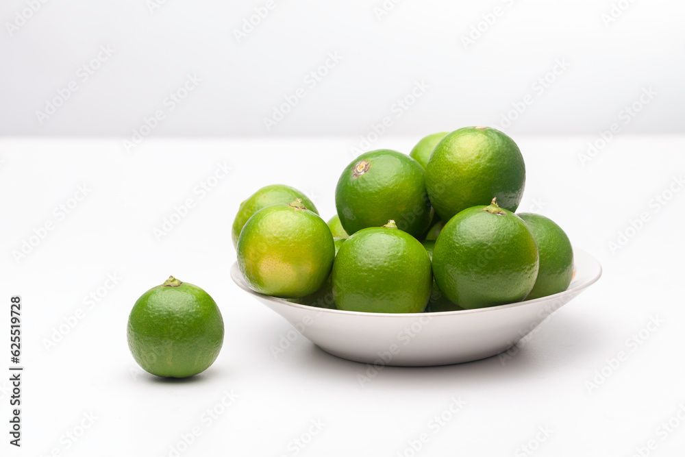 fresh lemons on plate on a white background fresh lemons on plate on a white background