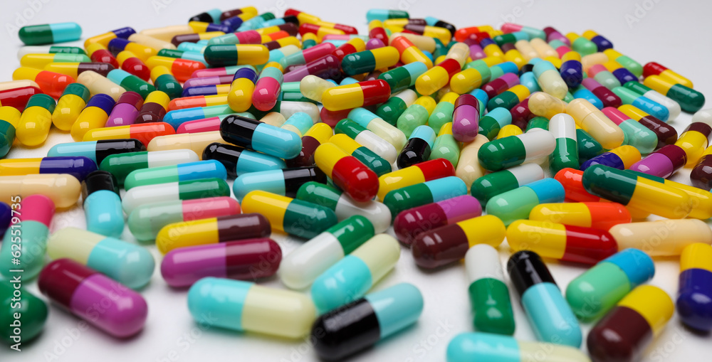 colored pill capsules placed on a white background colored pill capsules placed on a white background