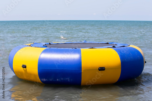 Sea trampoline in the form of a life buoy. Trampoline on the sea.