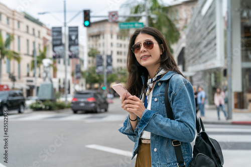 beautiful girl using smartphone to search the location of her favorite Jewelry shop