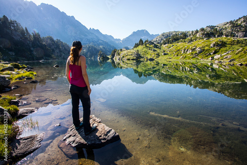 Young hiker girl summit to Ratera Peak in Aiguestortes and Sant Maurici National Park, Spain photo