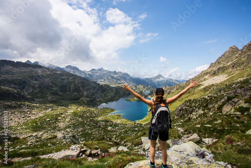 Young hiker girl summit to Ratera Peak in Aiguestortes and Sant Maurici National Park, Spain