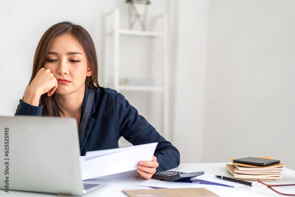 Smiling asian woman using calculator and calculate bills on laptop, paying bill, credit card, finance, tax, vat, credit card,  payment, tax refund, budget, debt, money.financial and accounting concept
