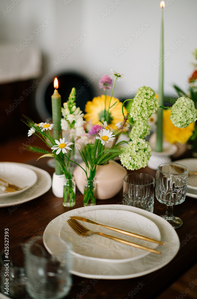 serving the table with fresh flowers and candles