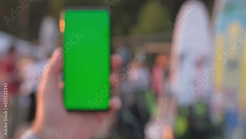 Wallpaper Mural Sup rental on the beach. Female hand with smartphone with green screen mockup on tropical beach background at sunset on summer vacations Torontodigital.ca