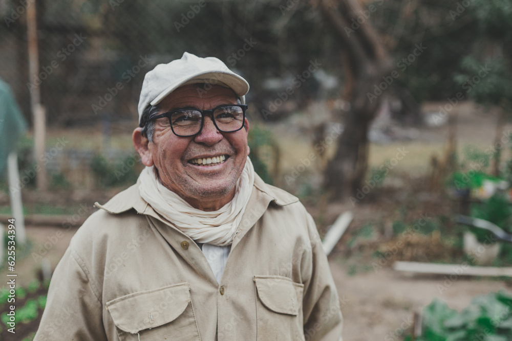 a man in his 70s smiling in his vegetable garden in winter a man in his 70s smiling in his vegetable garden in winter