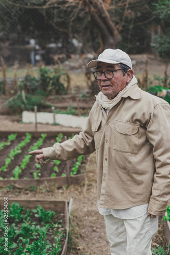 man in his 70's showing his vegetable garden