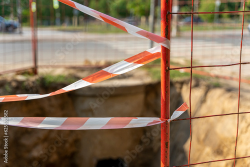  place of repair on the city street is fenced with signal tape