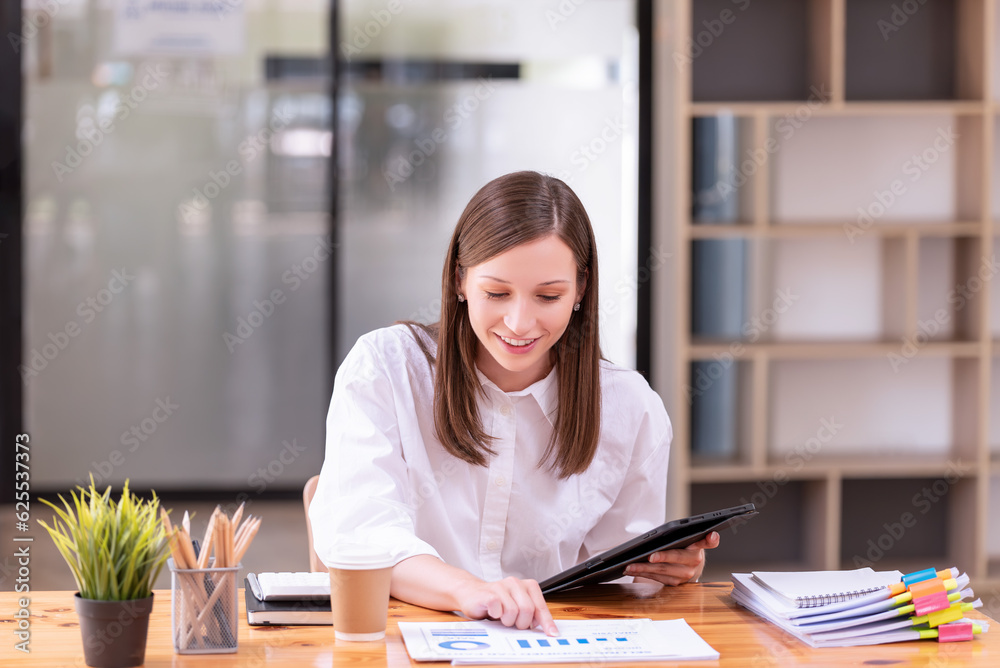 Businesswoman used a tablet working In the office room Businesswoman used a tablet working In the office room