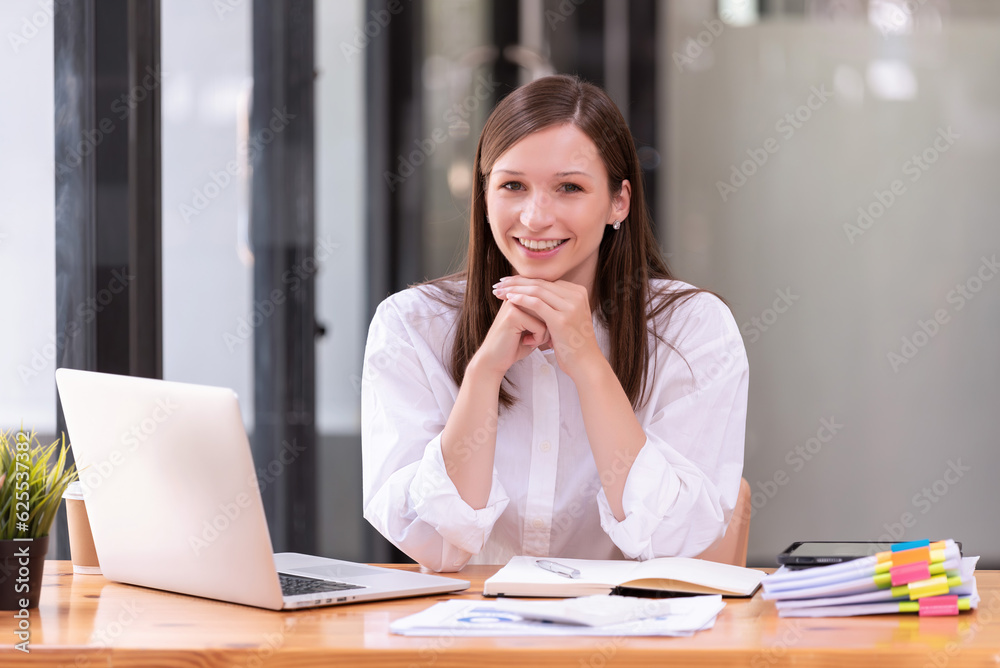 Businesswoman working in front of a laptop in the office. Businesswoman working in front of a laptop in the office.