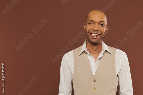 real people, positive african american man with myasthenia gravis syndrome standing on brown background, dark skinned, diversity and inclusion, real people, physical impairment