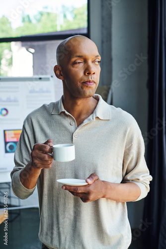 chronic illness, inclusion, african american man with myasthenia gravis disease holding cup of coffee, bold and dark skinned office worker with ptosis syndrome having coffee break