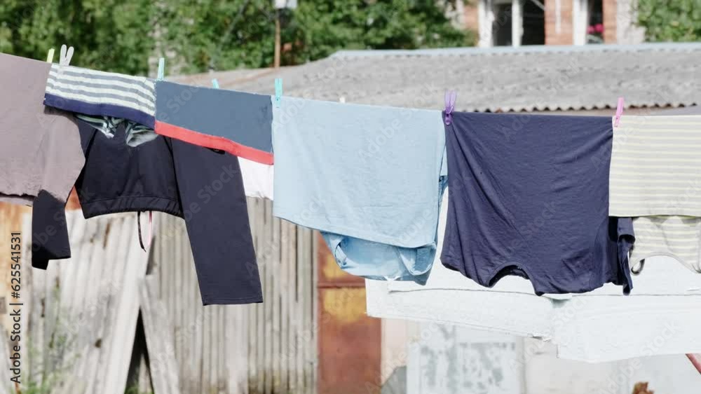 Various clothes are drying on the laundry line against the backdrop of the village.